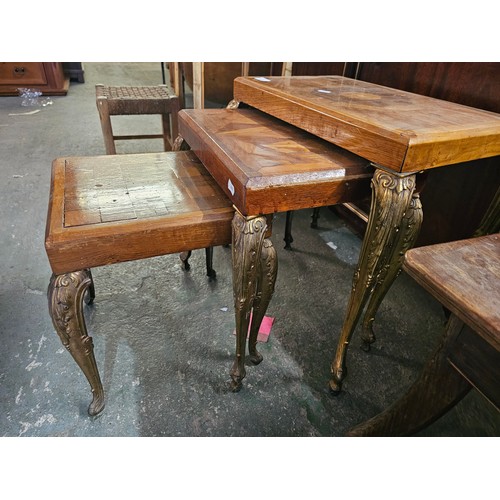 6 - Nest of wooden tables with ornate brass legs and inlaid marquetry
