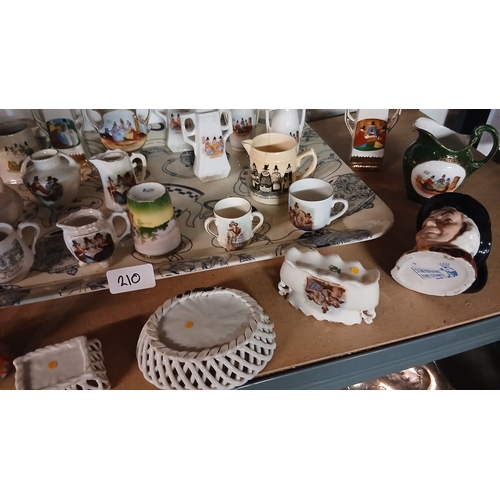 Large collection of miniature crested china souvenirs. Welsh lady pottery