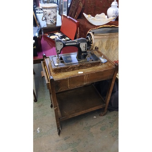 21P - HEXAGON vintage sewing machine and vintage wooden table on castors