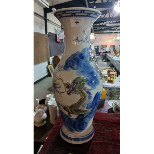 44 - Chinese porcelain vase decorated in a blue and white dragon motif, Features a prominent dragon—a sym... 