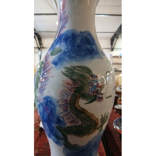 44 - Chinese porcelain vase decorated in a blue and white dragon motif, Features a prominent dragon—a sym... 
