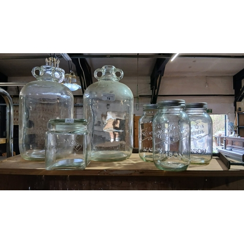 78 - a collection of vintage glass items, including several large demijohn bottles with ring handles and ... 