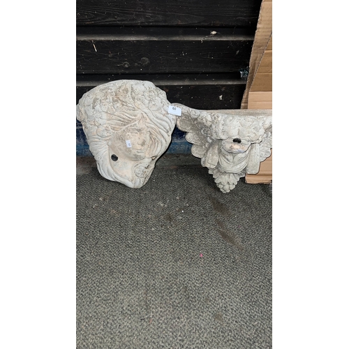 60 - Two concrete wall planters one in the form of a ladies head and one cherub design