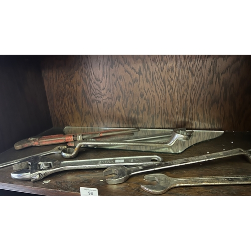 96 - several spanner wrenches and a pipe wrench.