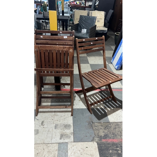 217 - Three folding wooden garden chairs