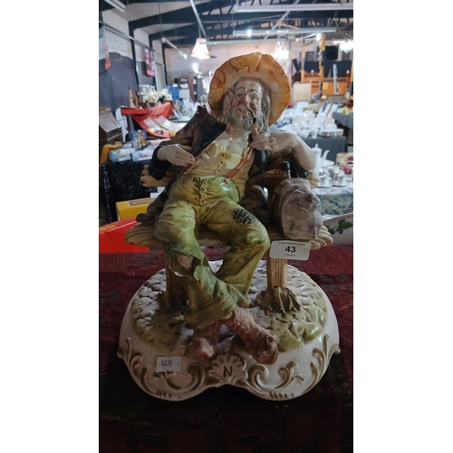 43P - vintage Capodimonte porcelain figurine depicting a tramp or hobo sitting on a park bench, holding a ... 