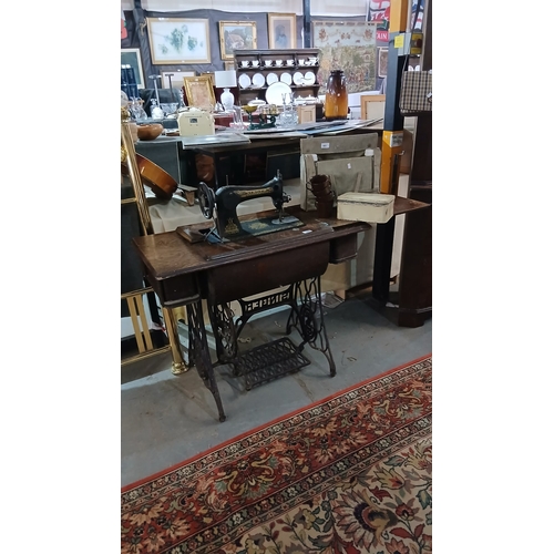 486 - vintage Singer treadle sewing machine set within a cast-iron and wood cabinet.