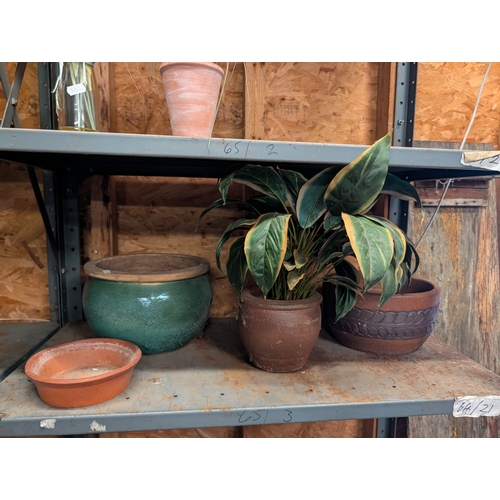 60G - collection of various garden pots, including a green glazed planter, a central terracotta pot, and a... 