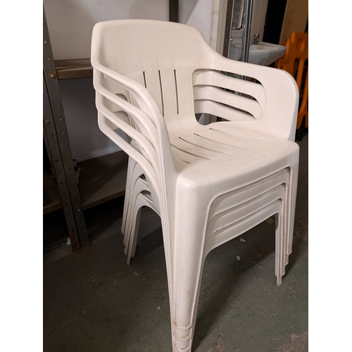 60U - white plastic patio garden chairs.