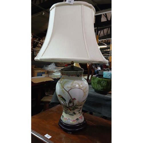 108 - Large decorative oriental-style porcelain table lamp featuring a hand-painted bird and floral design... 