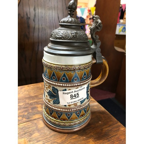 143 - Stein by Mettlach with metal lid and leaf decoration to pottery base