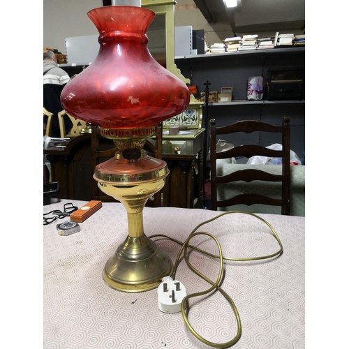 735 - Vintage oil lamp with red glass shade and glass chimney which has been converted to electric.