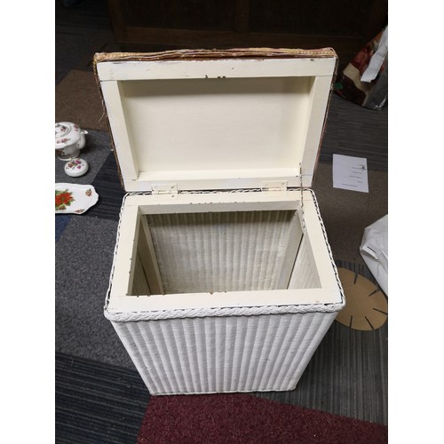 775 - Laundry basket with upholstered lid measuring 40 cms wide x 28 cms deep x 60 cms tall