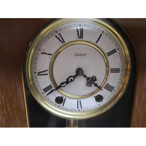 834 - Kienenger wall mounted clock measuring 58 cms x 25 cms complete with key