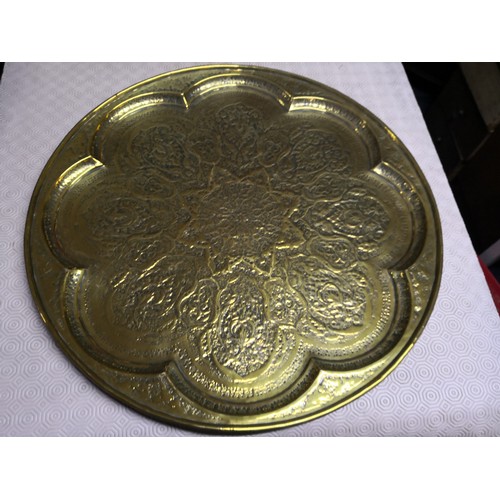 842 - 3 large embossed brass plates, large round plate measures 58 cms diameter, smaller round one is 50 c... 