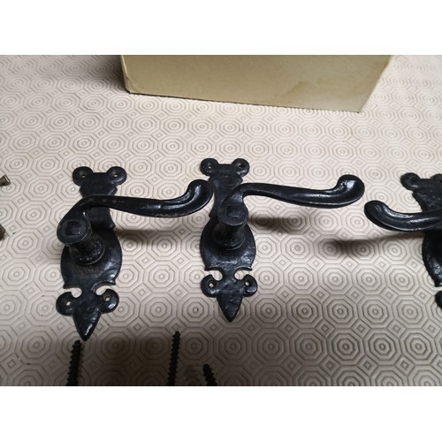 926 - Selection of Fleur-De-Lys cast iron door handles, coat hangars and castors