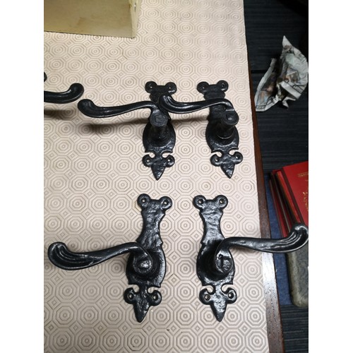 926 - Selection of Fleur-De-Lys cast iron door handles, coat hangars and castors