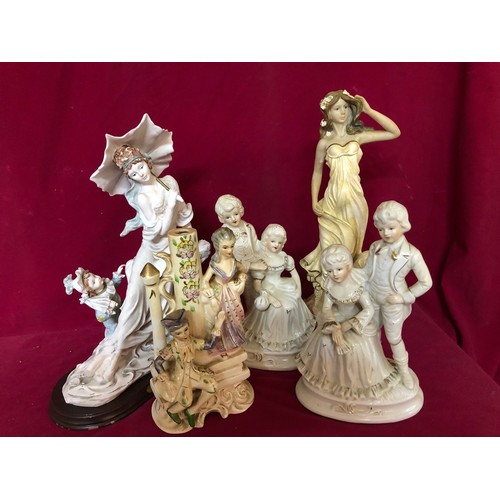 730 - Selection of ornamental figurines depicting couples  and female figures.