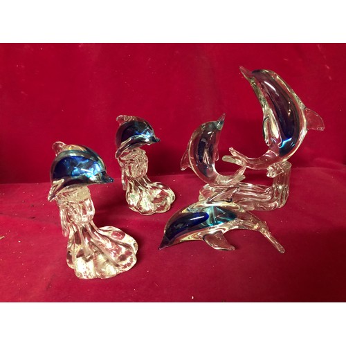 735 - Selection of 4 blue and white glass dolphins.