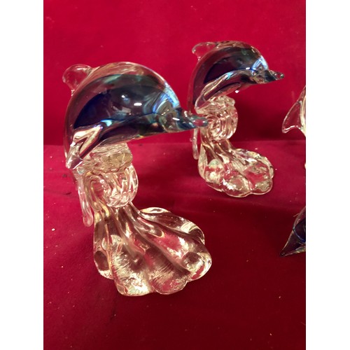 735 - Selection of 4 blue and white glass dolphins.