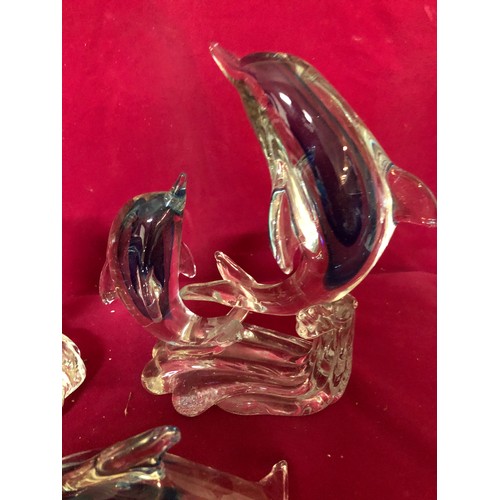 735 - Selection of 4 blue and white glass dolphins.