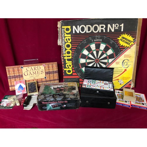 744 - Nodor no1 dartboard with a collection of other card games and domino set, playing cards and dice.