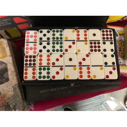 744 - Nodor no1 dartboard with a collection of other card games and domino set, playing cards and dice.