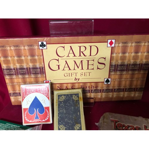 744 - Nodor no1 dartboard with a collection of other card games and domino set, playing cards and dice.