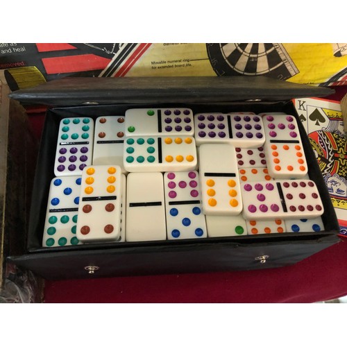 744 - Nodor no1 dartboard with a collection of other card games and domino set, playing cards and dice.