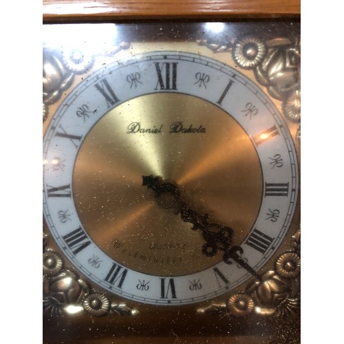 751 - A wall hanging Quartz clock with westminster chime in light wood by Daniel Dakota. Measures 62cms ta... 