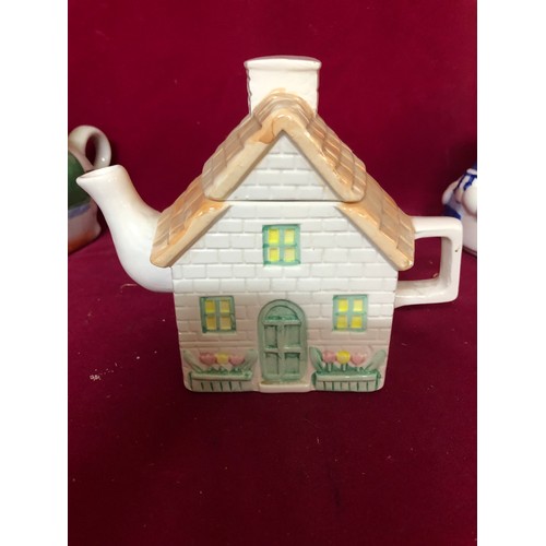 784 - Box of novelty teapots and money boxes.