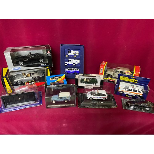 56 - 11 boxed diecast models including Burago, Welly and New Ray