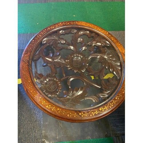 997 - Round ocassional table with glass top, intricate carved centre and brass inlaid surround measuring 5... 