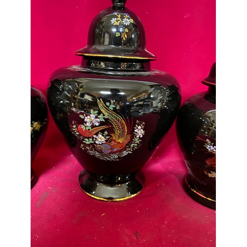 652 - Set of 3 decorative black and gold urns with lids, tallest is 27cms.