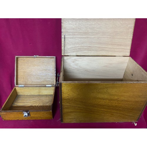 621 - 2 wooden boxes, one with decorative metal trim, one larger plain one with brass handles. Largest mea... 