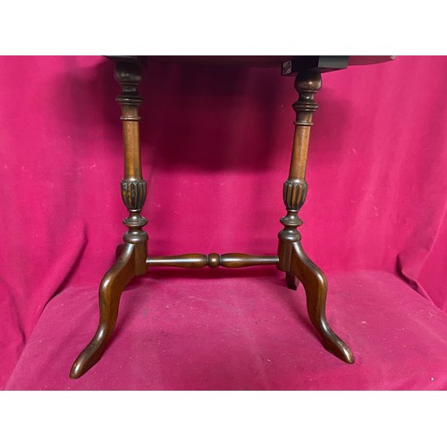 10 - Oval occasional table measuring 60 cms diameter with 2 pedestal legs