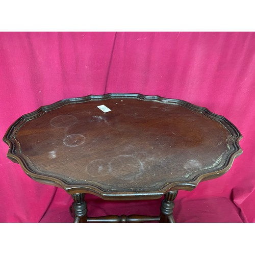 10 - Oval occasional table measuring 60 cms diameter with 2 pedestal legs