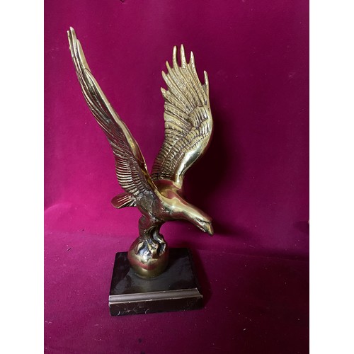 219 - 2 Eagles in gold, one in brass on plinth measuring 29 cms tall and one in metal measuring 23 cms tal... 