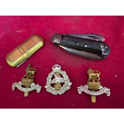 45 - Selection of Military cap badges, knife and trench art lighter.