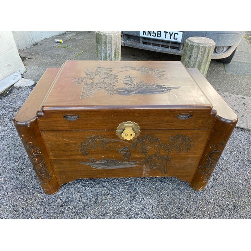 311 - Wooden camphor chest with carved Eastern scene measuring 100 x 59 without legs. Has wooden inset tra... 