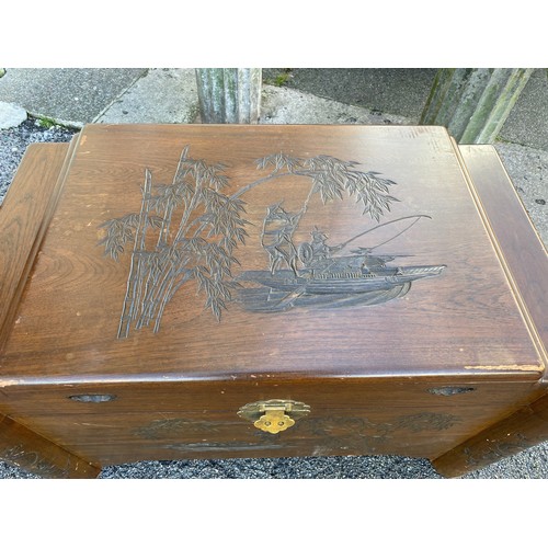 311 - Wooden camphor chest with carved Eastern scene measuring 100 x 59 without legs. Has wooden inset tra... 