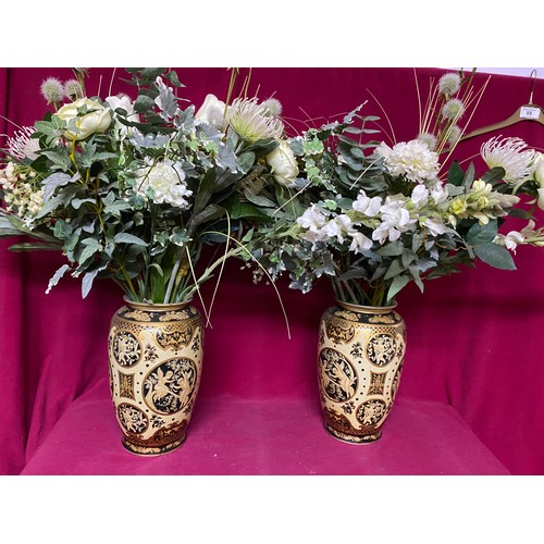 924 - Pair of vases in gold cream and black, 30cms tall. To include flowers