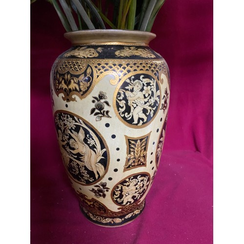 924 - Pair of vases in gold cream and black, 30cms tall. To include flowers