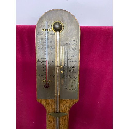 928 - Barometer in Oak with brass plate to top, 90cms tall.