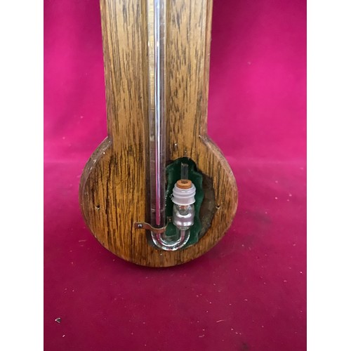 928 - Barometer in Oak with brass plate to top, 90cms tall.