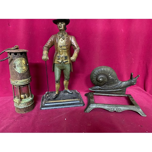 935 - Selection of metal ware including miners lamp, Man doorstop, shop bell and Snail. Man is 40cms tall