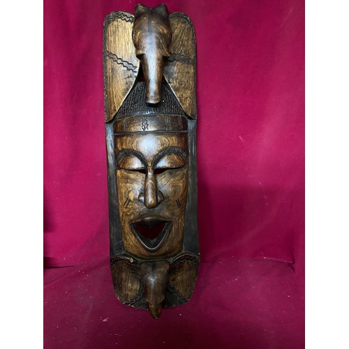 718 - 2 wooden African masks with largest measuring 63 cms tall