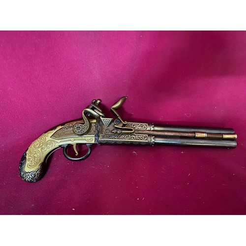 644 - Double barrelled replica flintlock pistol. In single trigger, over and under format with extensive e... 