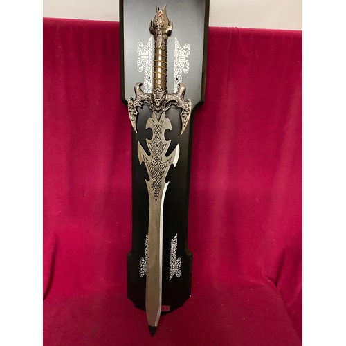 438 - Large decorative sword on wooden mount, sword measures 90cms