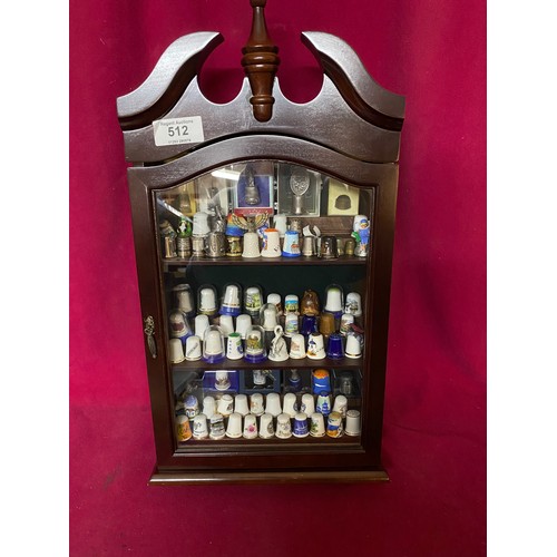 512 - Collection of 83 thimbles in display case consisting of porcelain, metal and wooden thimbles, some b... 